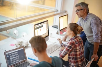 Teacher with students using computers