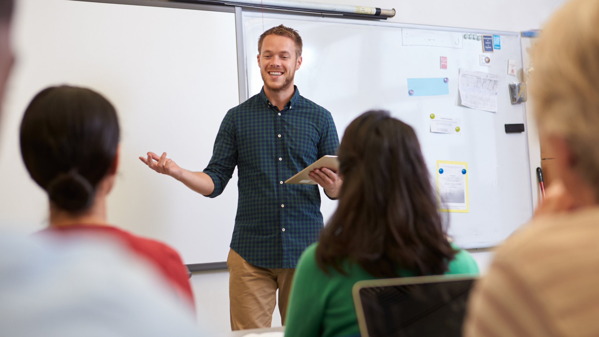 Teacher using a device to teach other adults